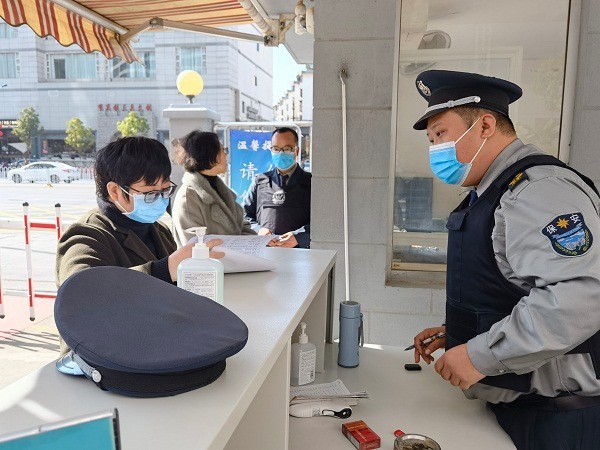驻区人民检察院纪检监察组组长罗弟菊在区检察院大门值班室，对外来人员身份登记、绿码通行码查验及体温测量工作进行监督检查.jpg